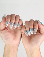 Model showcasing Aqua Wave trendy nails with summer beach background