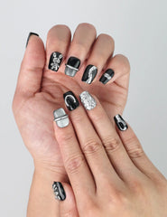 Close-up of Naillover’s handmade Singapore nails featuring black base and shimmering silver rabbit charms