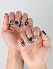 Side view of edgy black press-on nails with high-shine gloss and playful 3D bunny figures