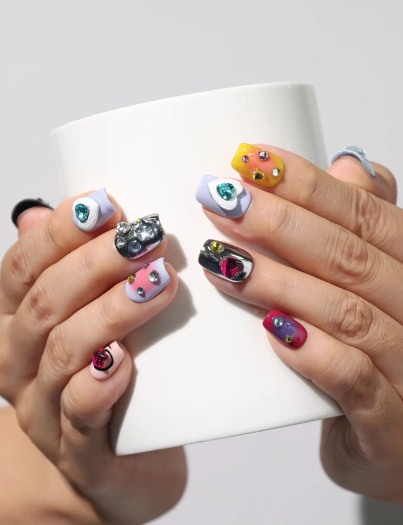 Coffin-shaped Singapore press on nails with heart accents, holding coffee cup – naillover handmade set