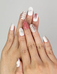 Hand wearing Naillover Autumn Floral Sparkle handmade press on nails featuring autumn floral patterns and glitter leaf details.