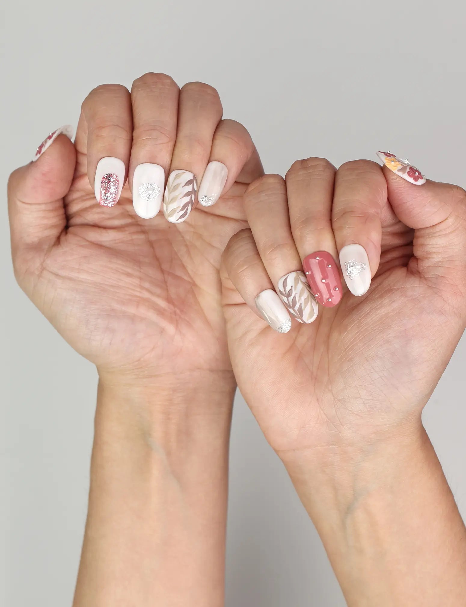 Naillover Autumn Floral Sparkle classic nails styled on hand, showcasing autumn-inspired vines and shimmering glitter.