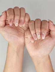 Naillover Autumn Whisper handmade press on nails styled on hand, showing chic ombre design with golden touches.