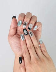 Close-up of Naillover’s handmade Singapore nails showcasing 3D balloon figures and holographic silver textures on glossy black base