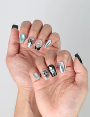 Side view of modern black square nails with statement balloon art and futuristic shimmer