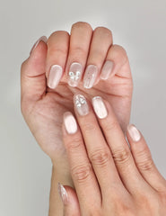 Close-up of Naillover Beige Elegance Singapore press on nails, featuring luminous cat eye nails with intricate butterfly and glitter accents.
