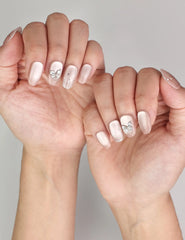 Naillover Beige Elegance trendy nails styled on hand, showcasing handmade cat eye shimmer nails with silver butterfly charm details.