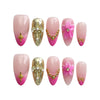 Product display of handmade pink press-on nails with glossy gold undertones, 3D flower nails, stars, and pearls