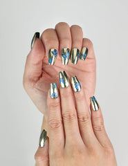 Close-up of Blue Aura handmade Singapore press on nails with golden finish and blue butterflies, worn for an elegant summer style.