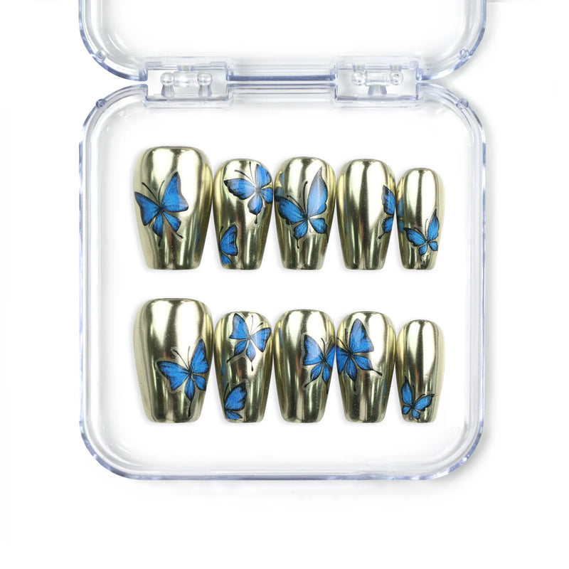 Blue Aura Singapore press on nails by naillover, featuring handmade golden sheen nails with 3D blue butterfly accents in a trendy summer design.