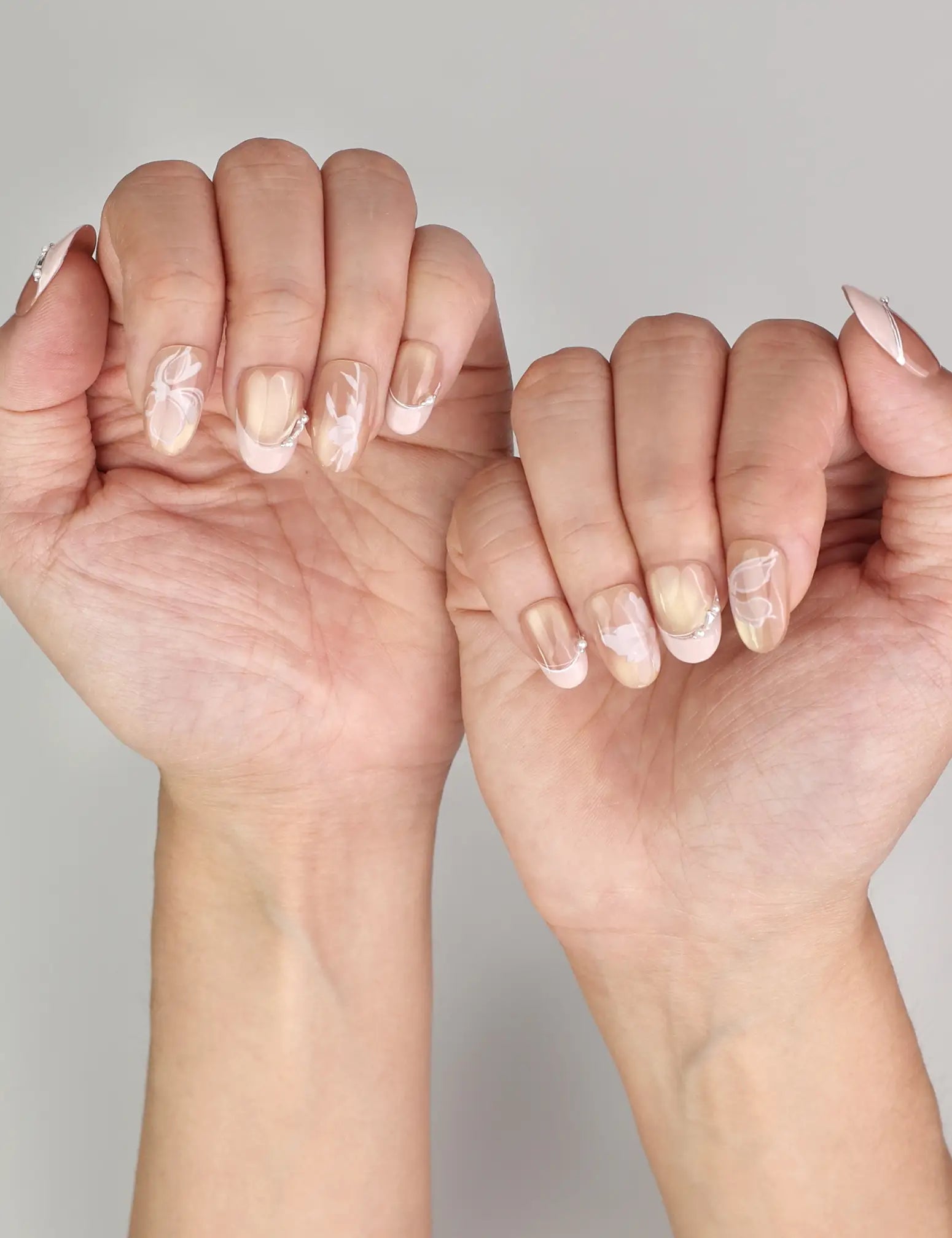 Naillover Blush Latte trendy nails styled on hand, showing handmade ombre nails with pearlescent sheen and metallic accents.