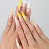 Hand showcasing stiletto-shaped press on nails with metallic yellow and galaxy-tone 3D swirl designs by Naillover