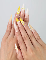 Hand showcasing stiletto-shaped press on nails with metallic yellow and galaxy-tone 3D swirl designs by Naillover
