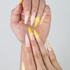 Close-up of handmade stiletto nails from Singapore with dramatic 3D metallic swirls in deep yellow and cosmic hues