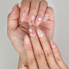 Close-up of Naillover Bunny Blush Singapore press on nails showing cute rabbit and flower motifs with delicate golden highlights.