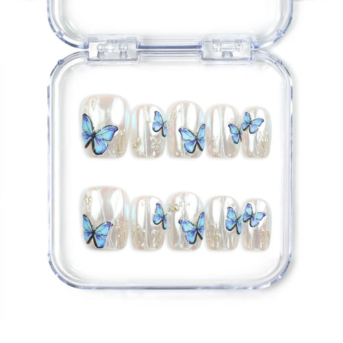 Butterfly Light short press-on nails featuring a chrome base and vivid blue butterflies from Naillover’s handmade press on nails Singapore collection.