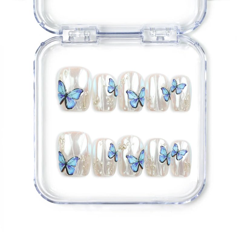 Butterfly Light short press-on nails featuring a chrome base and vivid blue butterflies from Naillover’s handmade press on nails Singapore collection.