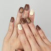 Hand wearing Caramel Glaze cat eye press on nails SG with dark brown glossy finish.