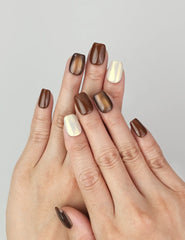 Hand wearing Caramel Glaze cat eye press on nails SG with dark brown glossy finish.