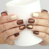 Hand holding a cup while wearing Naillover Caramel Glaze cat eye handmade press on nails SG.
