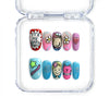 Colorful short oval press-on nails with doodles, smiley faces, and pop graphics from Singapore brand Naillover.