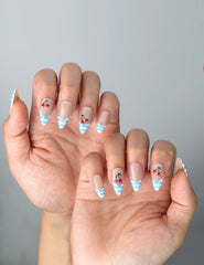 Side view of almond-shaped nails with playful fruit accents and checkered French tips in a fresh summer style