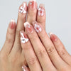 Hand wearing Cherry Bow Crush handmade press on nails with pink gingham and 3D bows from naillover Singapore collection