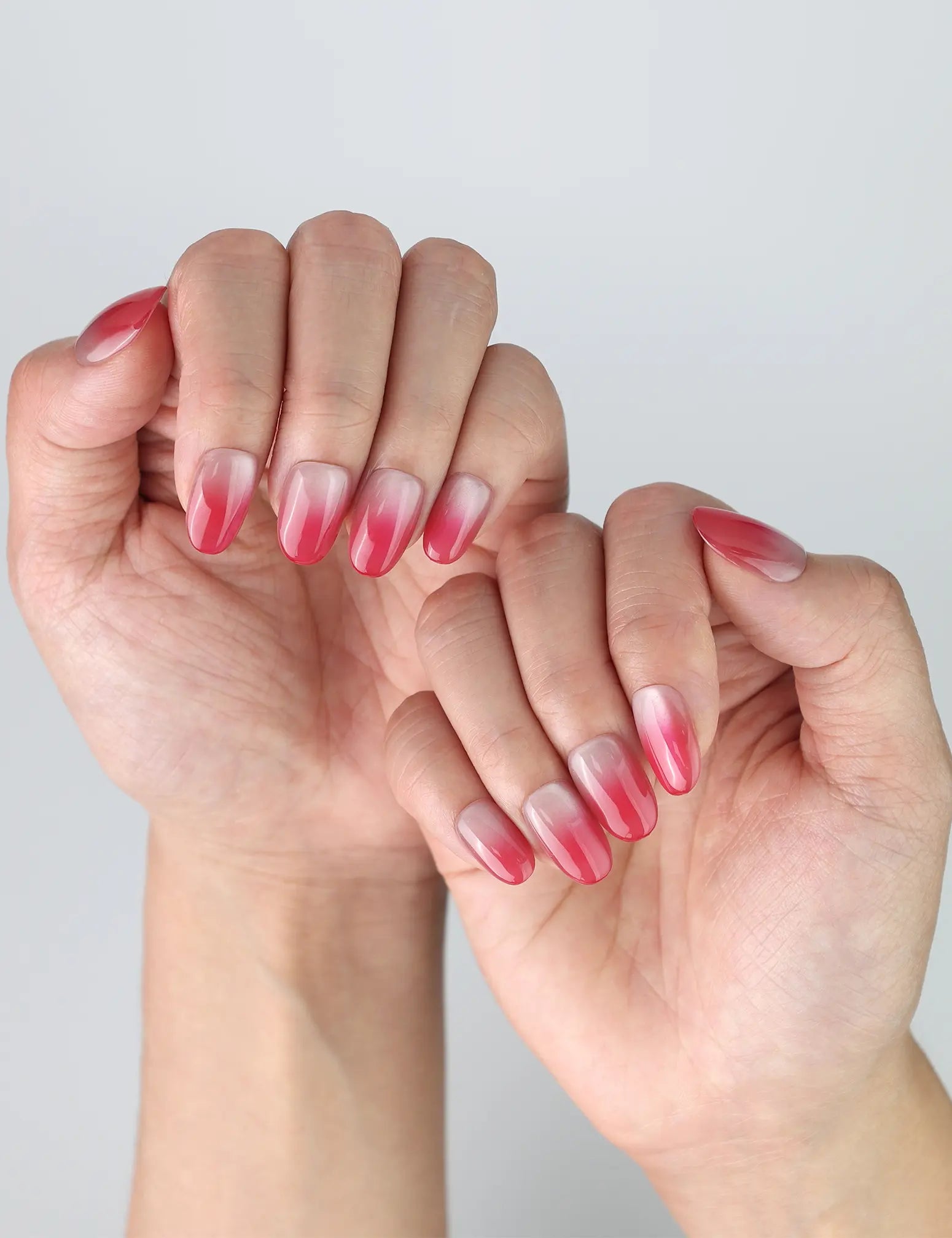 Side view of pink oval nails with glistening cat-eye finish and delicate gradient effect
