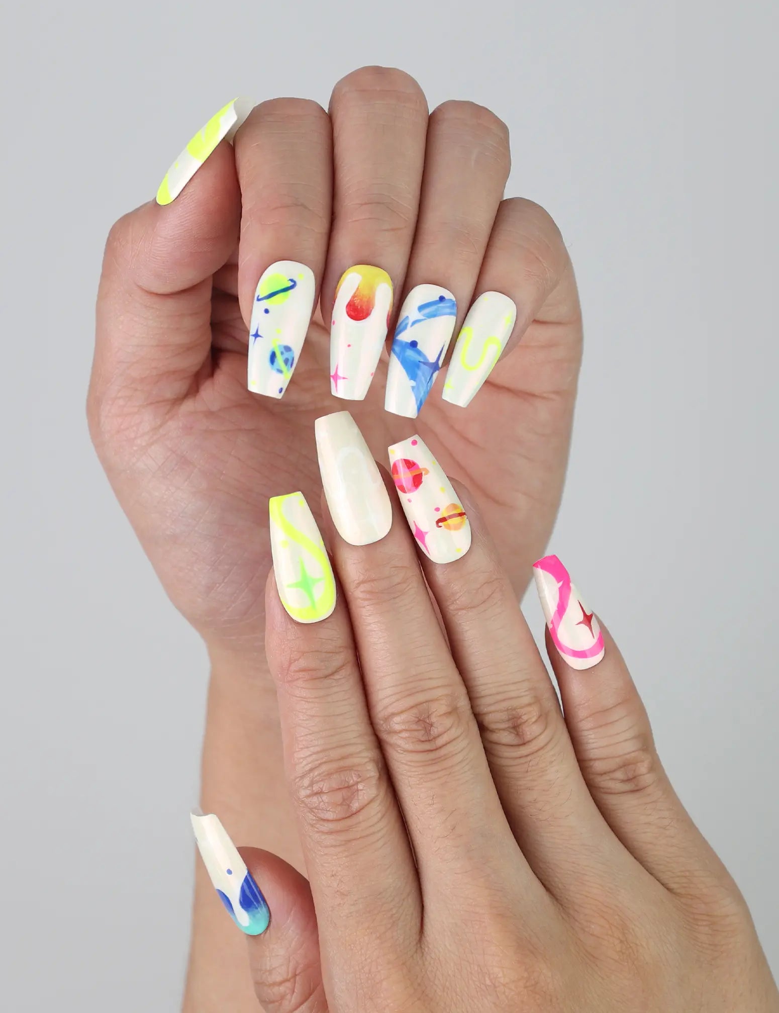 Singapore handmade press on nails in a cute coffin shape, featuring colorful line art, stars, and playful artistic details
