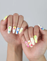 Medium length coffin nails with bold neon colors, quirky squiggles, and abstract charm for a fun statement look
