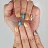 Close-up of Cozy Plaid Glaze plaid short coffin press on nails in brown chrome, Naillover Singapore collection