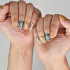 Naillover handmade Cozy Plaid Glaze short coffin nails in plaid and cat-eye shimmer shown on model hand