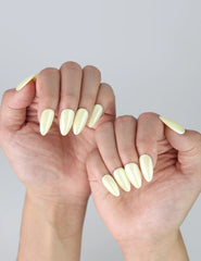 Side angle of pastel yellow short nails, ideal for minimalists who love a gentle, joyful look