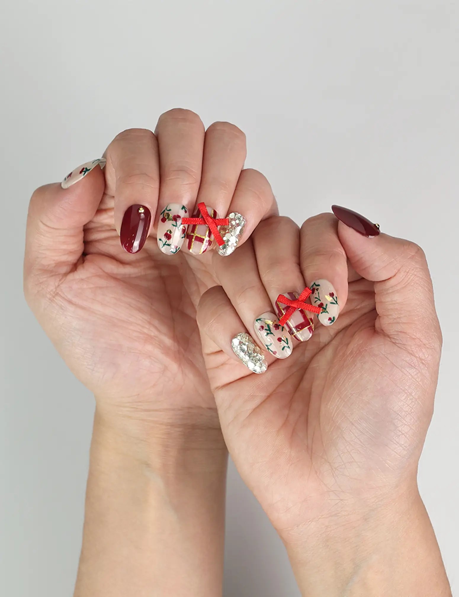 Model showcasing Crimson Bow handmade press on nails Singapore style, adding holiday cheer to a chic outfit