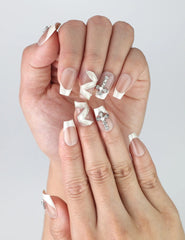 Close-up of Naillover’s beige coffin nails featuring intricate silver zigzags and sparkling crystal accents