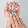 Close-up of Naillover’s handmade Singapore nails featuring cool blue tones, glossy sheen, and gem-like embellishments