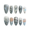 Product display of Naillover’s blue almond press-on nail set with pearlescent shine and 3D rhinestone accents