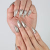 Fingers slightly curled to display Naillover’s Singapore handmade chrome silver nails with jewel embellishments
