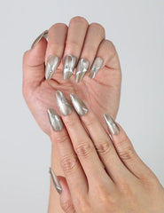 Fingers slightly curled to display Naillover’s Singapore handmade chrome silver nails with jewel embellishments