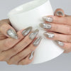 Hand holding a cup while flaunting metallic chrome medium press on nails with subtle gem sparkle by Naillover