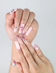 Close-up of Naillover’s handmade pink marble coffin nails featuring shimmering silver gem charms and soft gradient blend