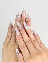 Model wearing Dolce Peach Singapore press on nails in glossy pink coffin shape with silver chain accents by naillover