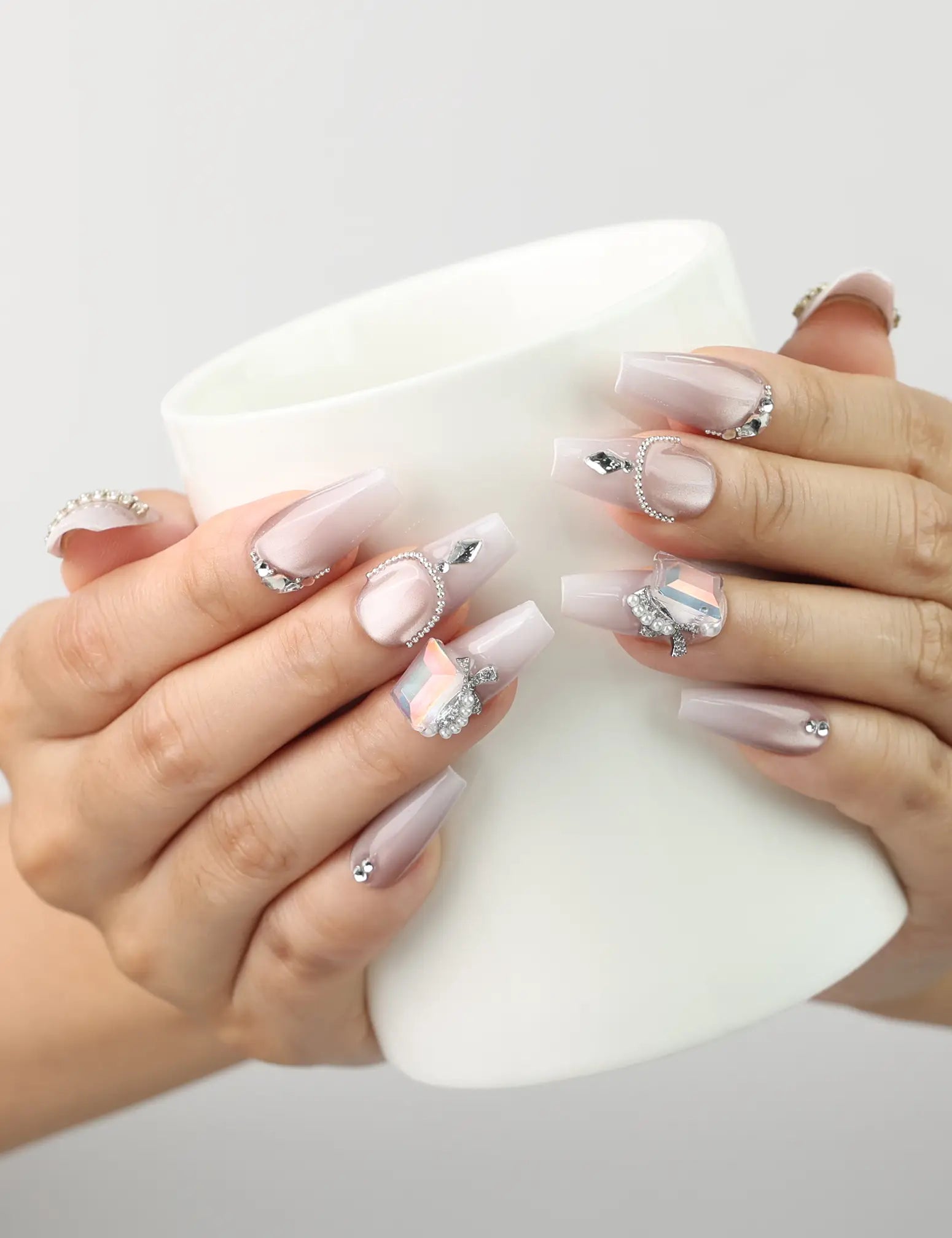 Dolce Peach pink coffin Singapore press on nails with silver chain accents, model holding a coffee cup