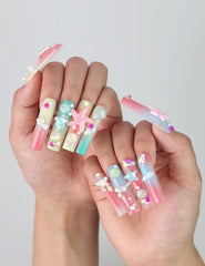Pose highlighting sculptural pipe nails with sea wave textures, pastel blooms, and golden starfish details by Naillover