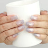 Eclipse Stars pastel cat eye nails by naillover holding a glass cup, showcasing salon-quality shine