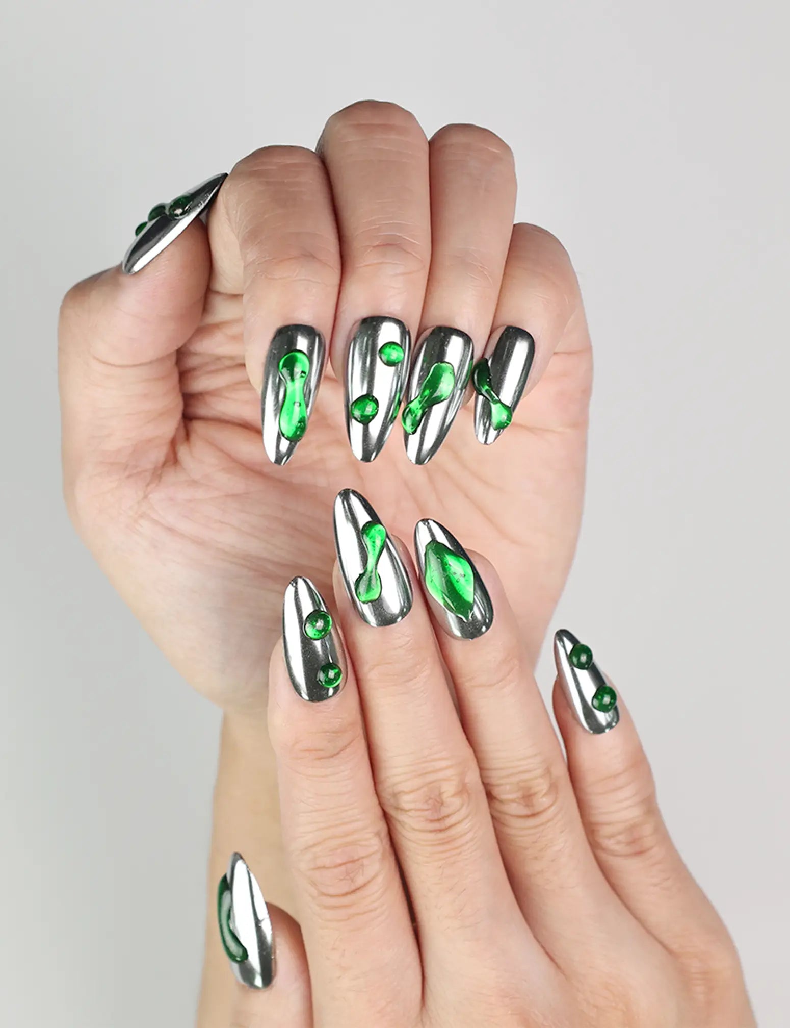 Close-up of Emerald Wave handmade press-on nails Singapore, featuring silver base and green wave accents by naillover