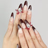 Model wearing Eternal burgundy press-on nails with silver accents, Singapore handmade nails by naillover