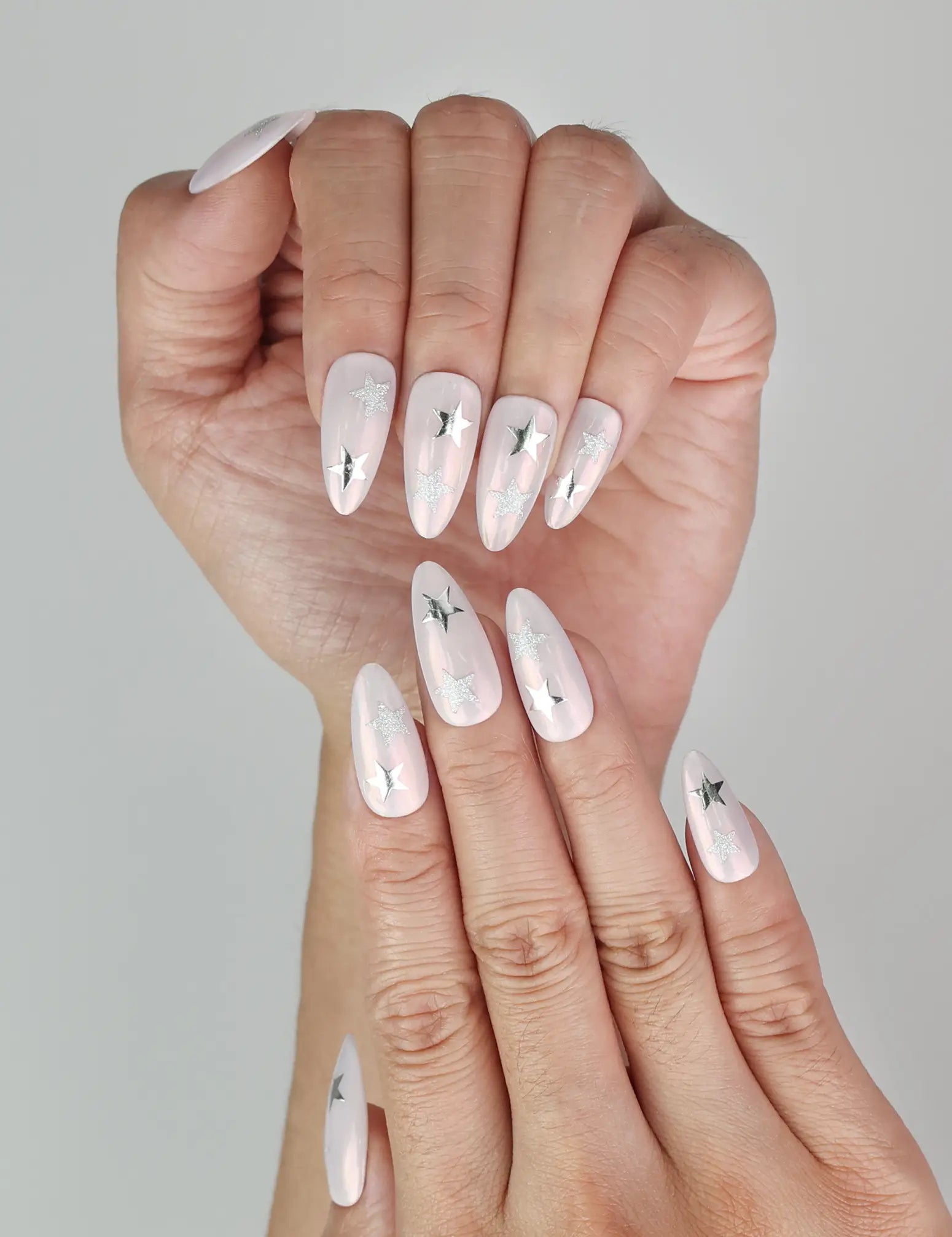 Close-up of Ethereal Stars pink press-on nails with silver star accents, Singapore handmade nails by naillover