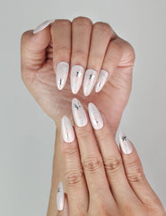 Close-up of Ethereal Stars pink press-on nails with silver star accents, Singapore handmade nails by naillover
