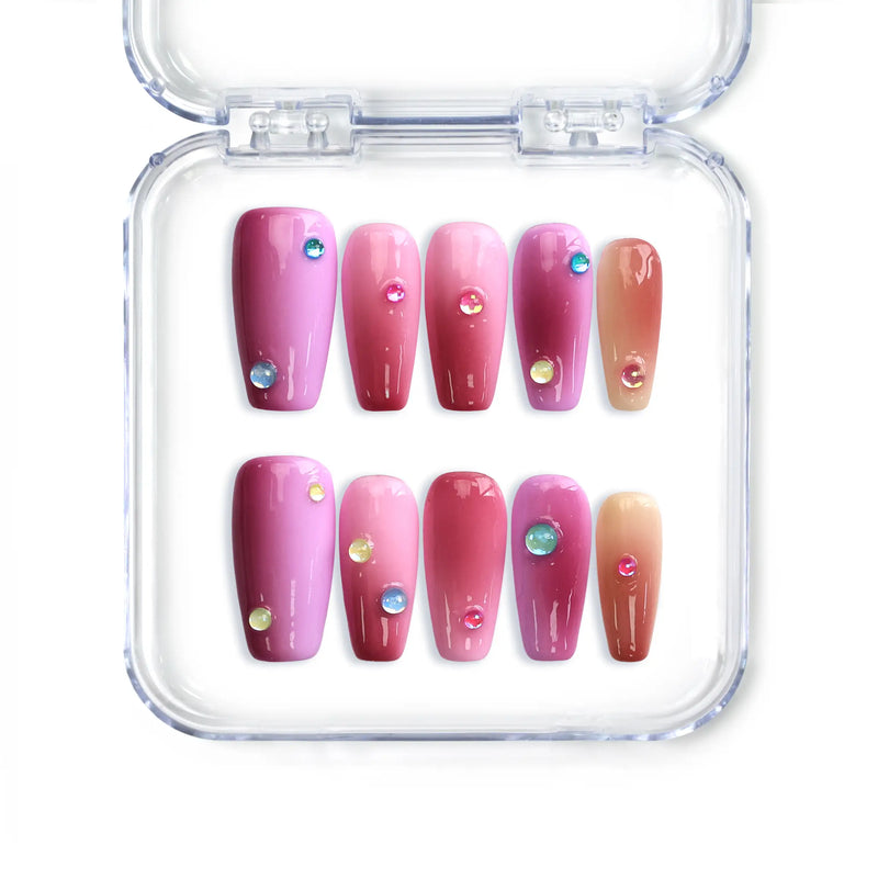 Handmade medium coffin Singapore press on nails with pink to red ombre and sparkling iridescent gems.